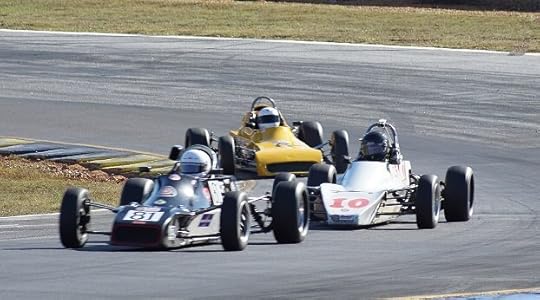 Drivers of .three different makes of Formula Fords charge up hill toward the Bridge. (Clark McInnis Photo)