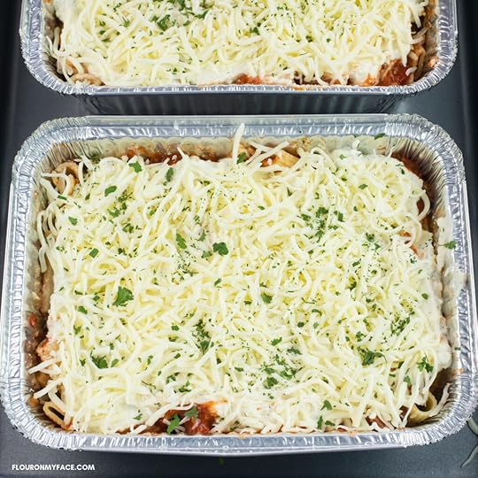 image of aluminum trays that are filled with baked ziti ready for the freezer.