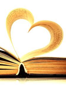 Photo of open book. Pages shaped into a heart.