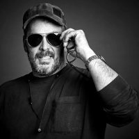 Maker Jimmy DiResta taking off regular glasses and stylishly putting on sunglasses