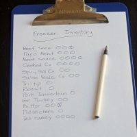 freezer inventory sheet on blue clipboard with pen