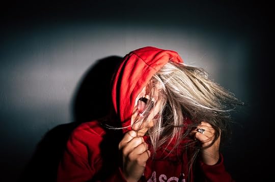 Teenager wearing red hoodie and screaming