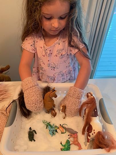 girl playing with toy horses