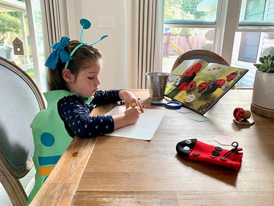girl coloring at table