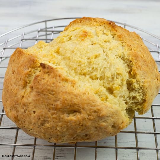freshly baked round loaf of Irish Soda Bread on a metal cooling rack.