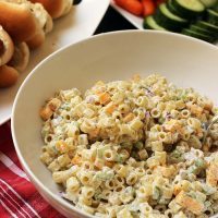 bowl of macaroni salad on table with other dishes