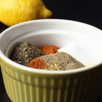 spices in green bowl with lemon in background