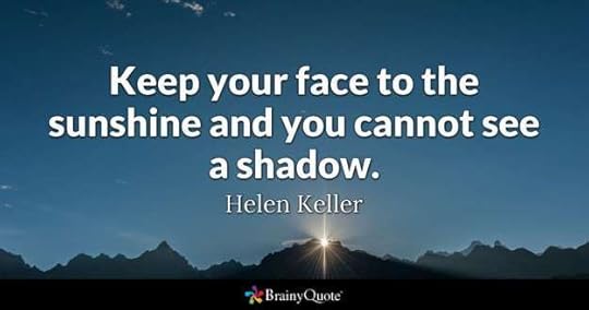 facing your fear by facing the sunshine. The sun bursts above mountain tops.