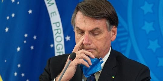 BRASILIA, BRAZIL - MARCH 20: Jair Bolsonaro President of Brazil takes off his protective mask to speak to journalists during a press conference about outbreak of the coronavirus (COVID - 19) at the Planalto Palace on March 20, 2020 in Brasilia, Brazil. (Photo by Andressa Anholete/Getty Images)