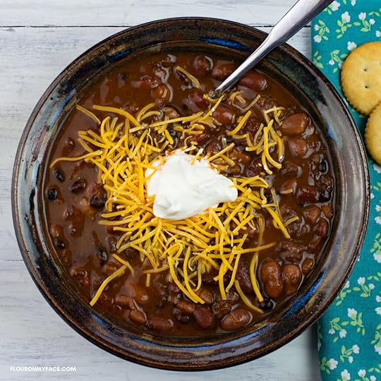 A bowl of Turkey Chili topped with shredded cheese and sour cream