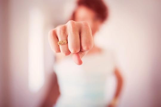 a girl punching with a gold ring on her finger