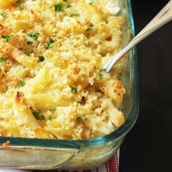 spoon digging into pan of Overnight casserole