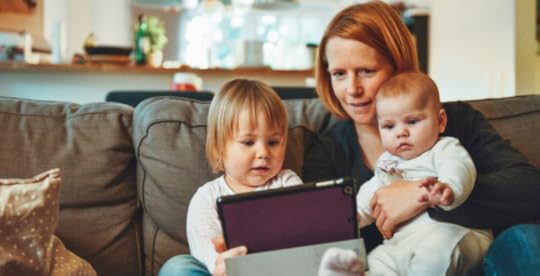 Family sitting on couch at home together