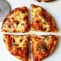 deep dish pineapple pizza cut into quarters