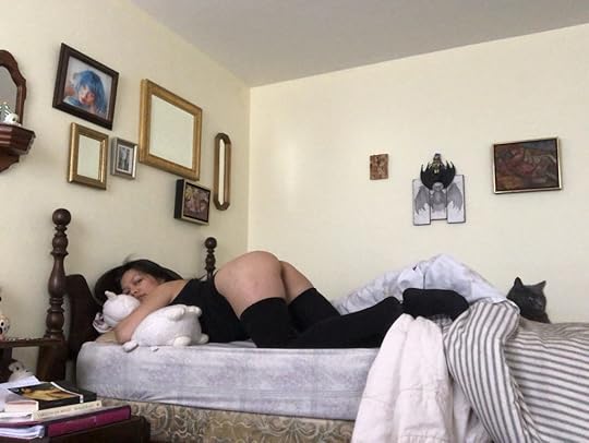 May Ling Su bent over booty in bed, wearing black thigh high stockings.