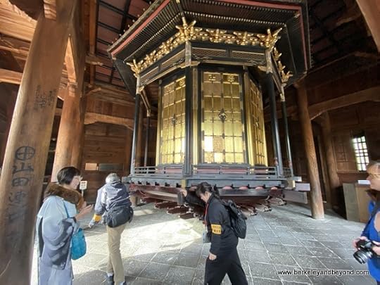 visitors push prayer wheel in Kyozo at Zenkoji Temple in Nagano City, Japan