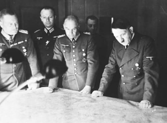 Hitler looking at a map with generals