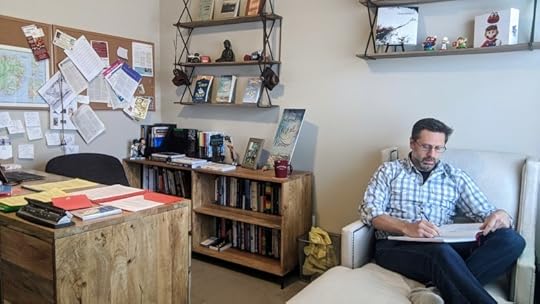 Doug Walsh writing first draft with pen and paper.