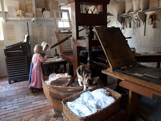 Image: young girls in period costume at historic printing press