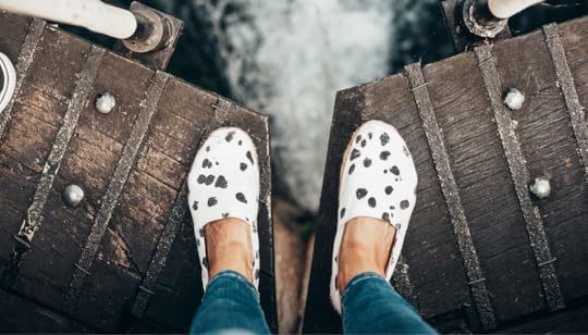 feet on bridge over water