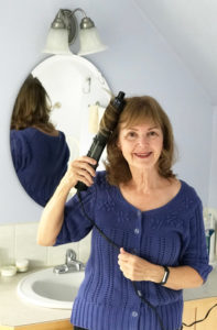 Elinor Florence using brush dryer to create curly hair