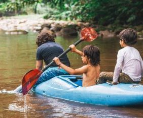 Three sons paddling down river
