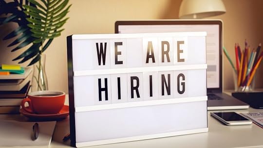 We are recruiting and hiring text on light box on desk office