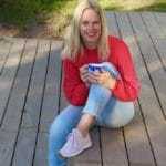 Mandi Hart sitting on the deck with coffee in her hand