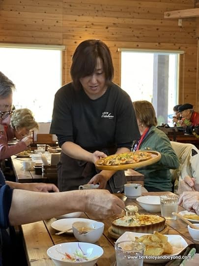 server fills table at Ortolana pizza cafe in Aomori, Japan