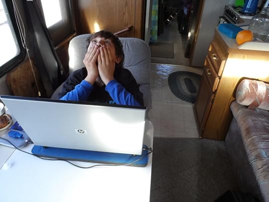 school-at-home young boy head in hands, open laptop