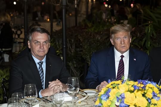 FILE - In this March 7, 2020, file photo President Donald Trump is seated before a dinner with Brazilian President Jair Bolsonaro, left, at Mar-a-Lago in Palm Beach, Fla. Bolsonaro’s communications director, Fábio Wajngarten, tested positive just days after traveling with Bolsonaro to a meeting with Trump and senior aides in Florida. (AP Photo/Alex Brandon, File)