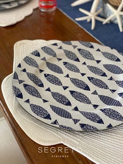 blue & white fish charger on shell placemat