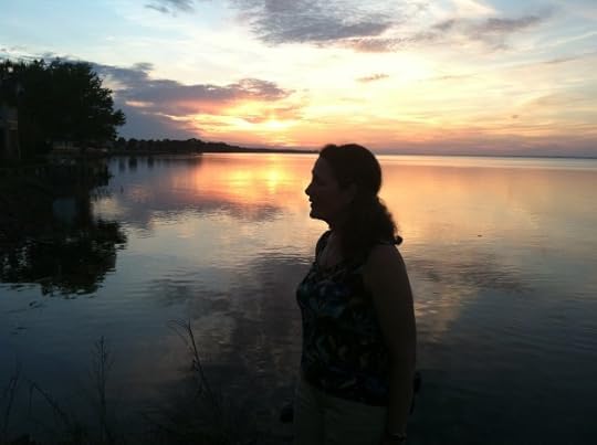 Choctawhatchie Bay at late sunset with author's profile silhouetted against the water reflecting the sunlit clouds