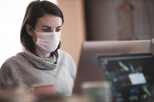 treated - a woman in a mask in front of a laptop,