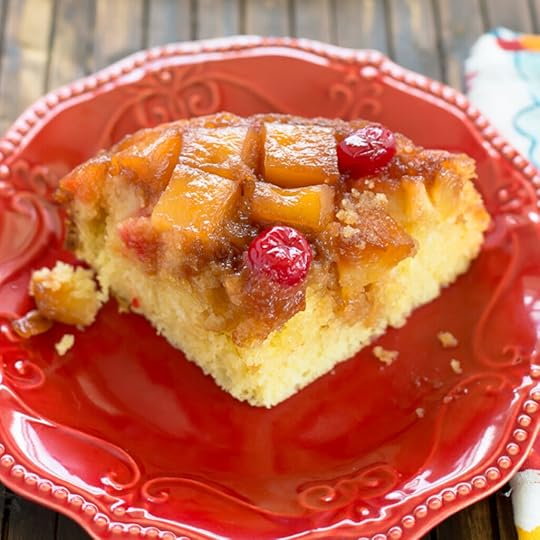 A slice of Crock Pot Pineapple Upside Down Cake on a red dessert plate