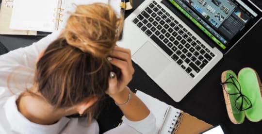 Stressed woman leaning over laptop