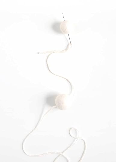 pulling needle through felted ball