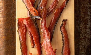 Salmon jerky on a wooden platter