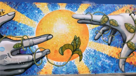 wall art showing hands reaching toward each other implying a gap analysis