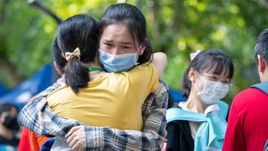 A student hugs her teacher before entering an exam site during the 2020 National College Entrance Exam