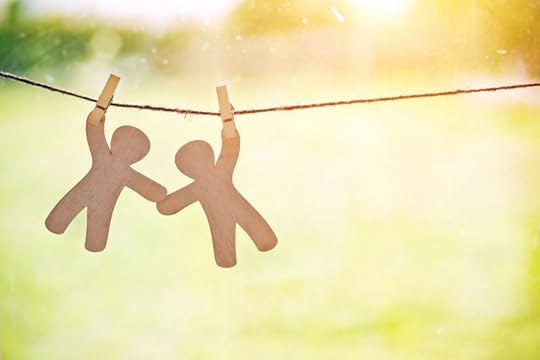 paper dolls holding hands on clothesline support