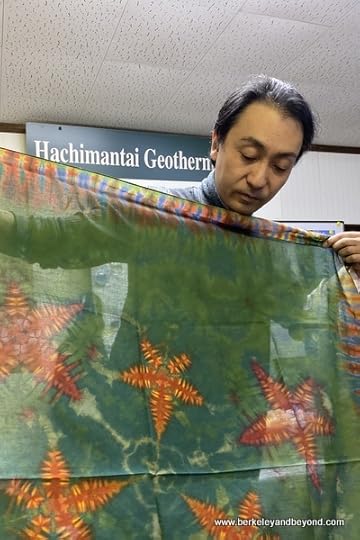 instructor holds sample tie-died cloth with starfish design at Geocolor: Hachimantai Geothermal Dyeing in Hachimantai city, Japan