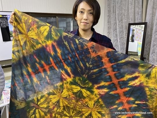 instructor holds sample tie-died cloth at Geocolor: Hachimantai Geothermal Dyeing in Hachimantai city, Japan