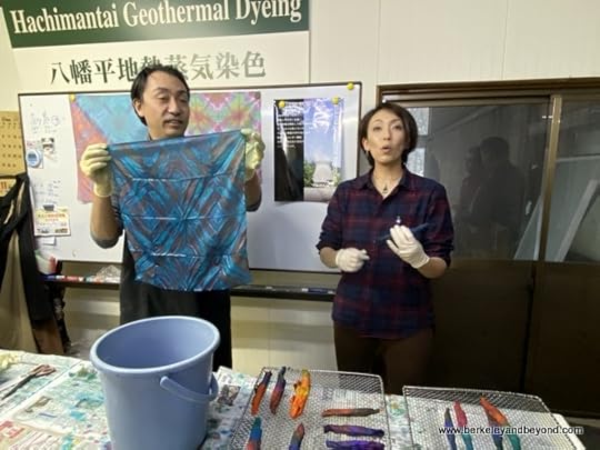 instructor displays student's tie-dyed cloth at Geocolor: Hachimantai Geothermal Dyeing in Hachimantai city, Japan