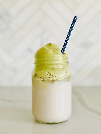 blogilates whipped matcha recipe in glass jar on counter with blue straw