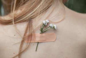 bandaid with flower on woman's back