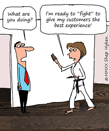 Woman in white gi standing in a karate pose ready to fight