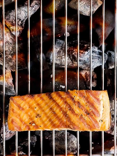 A piece of grilled salmon on an open grill to how how to grill salmon.