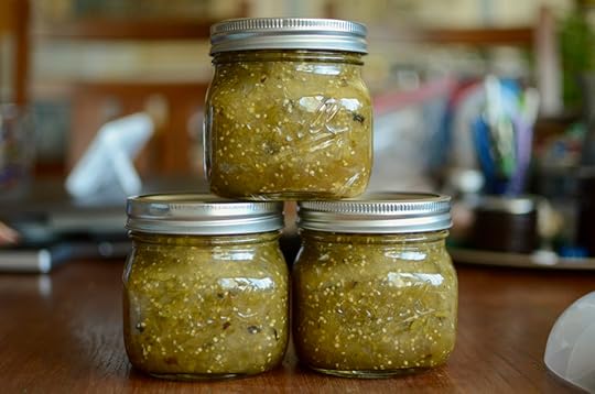 Three squat pint jars of bright green roasted salsa verde.