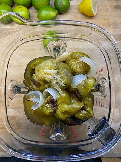 Roasted tomatillos, onions, and jalapenos in a blender.